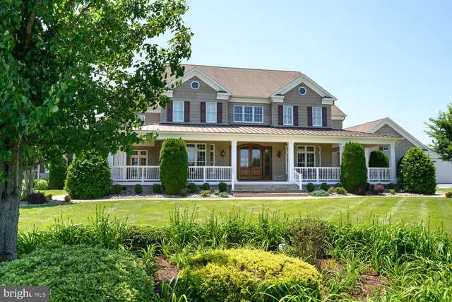 a living room with furniture fireplace and a large window