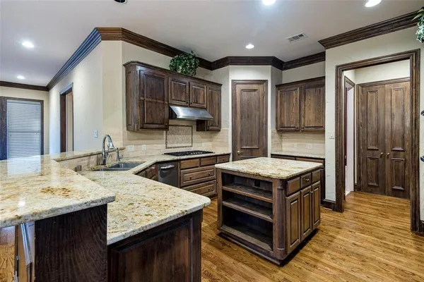 a bathroom with a granite countertop shower a sink and vanity