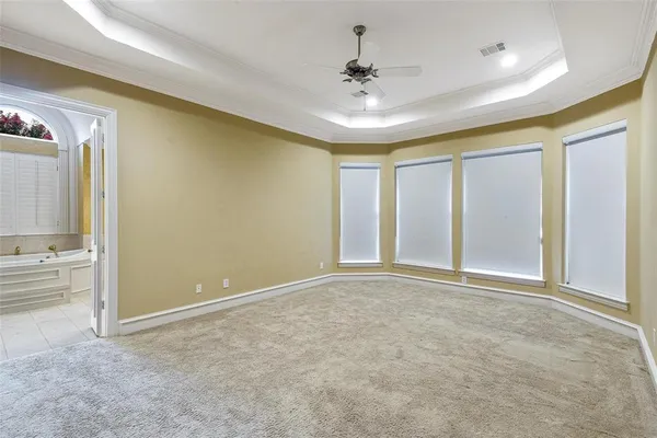 a bathroom with a granite countertop toilet sink and mirror