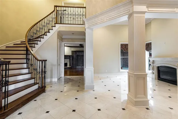 a kitchen with stainless steel appliances granite countertop a refrigerator a sink dishwasher a oven with white cabinets and wooden floor