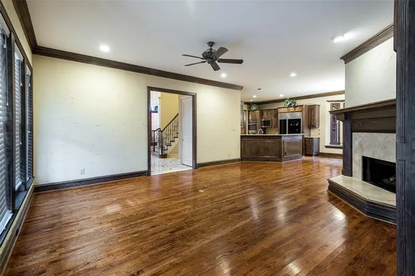 a view of an empty room with window and a ceiling fan