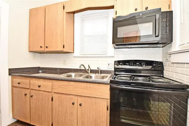 a view of livingroom with window fireplace and windows