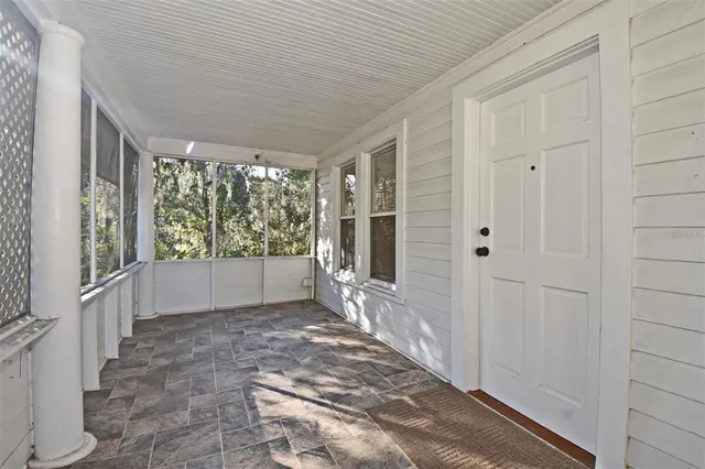 a big room with wooden floor and windows