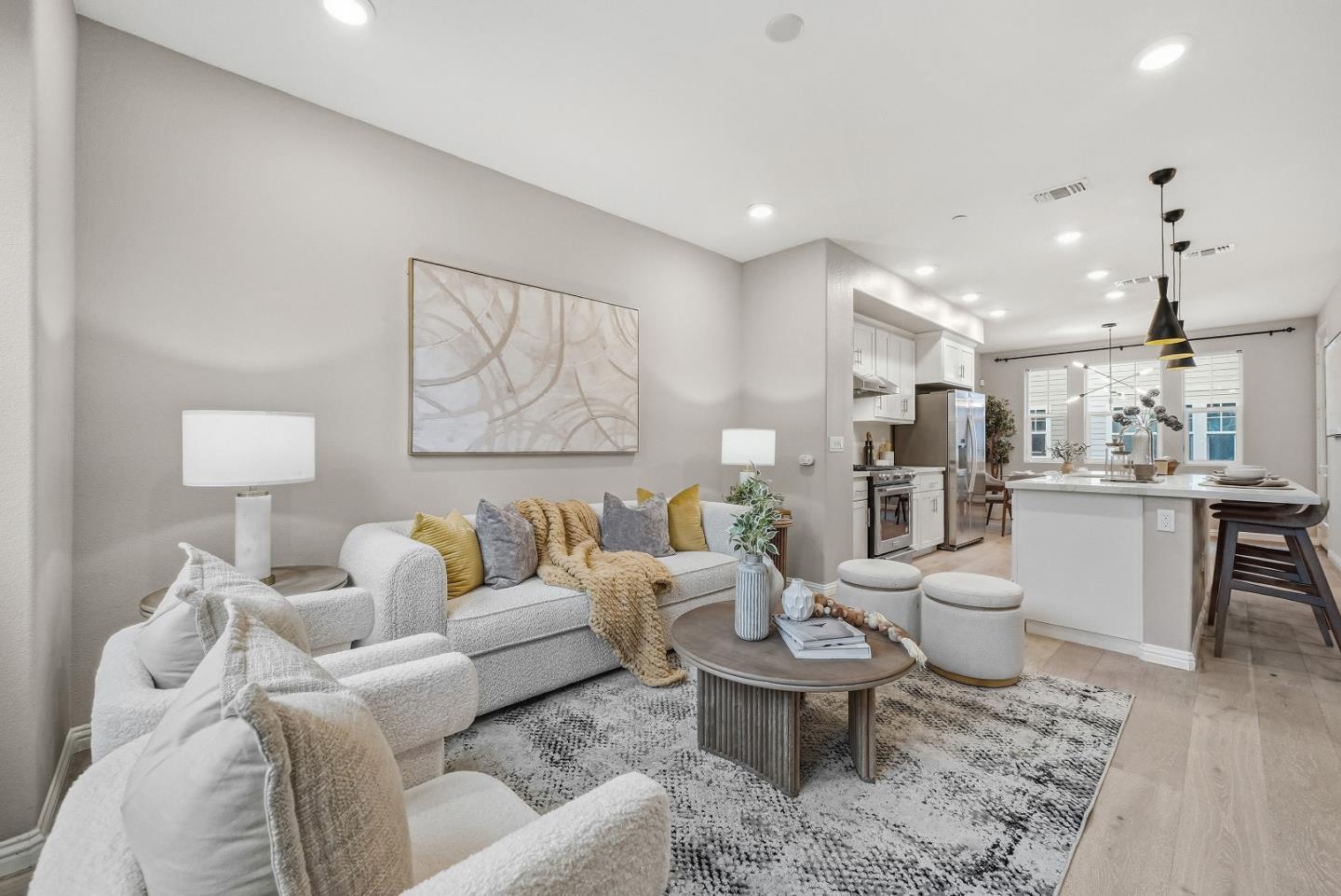 a living room with furniture a rug and kitchen view