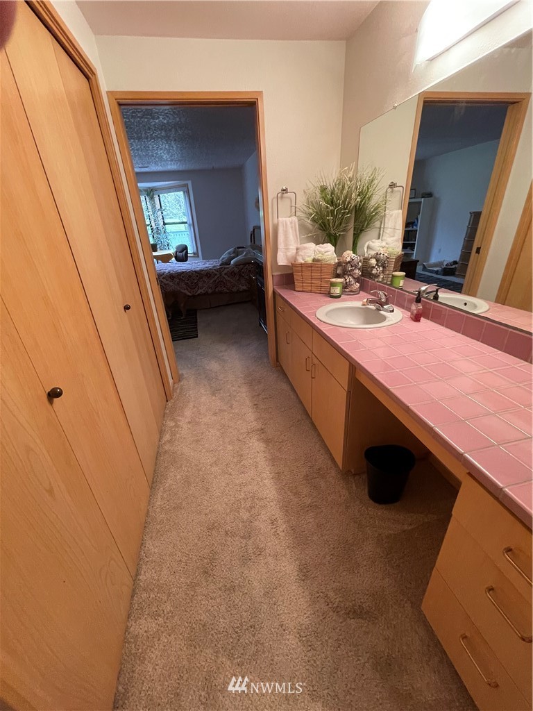 3300 Northeast 164th Street, Unit H2 Ridgefield, WA 98642 - Photo 11 of 24 a bathroom with a sink a mirror and a bathtub