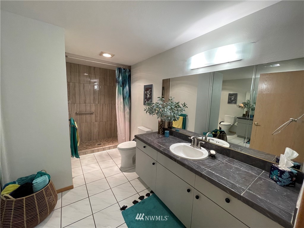 3300 Northeast 164th Street, Unit H2 Ridgefield, WA 98642 - Photo 13 of 24 a spacious bathroom with a granite countertop sink a toilet and shower