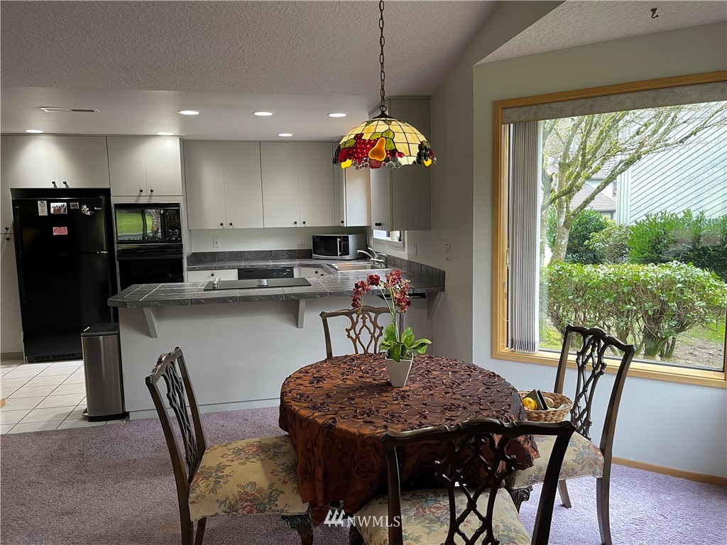 3300 Northeast 164th Street, Unit H2 Ridgefield, WA 98642 - Photo 17 of 24 a view of a dining room with furniture window and outside view