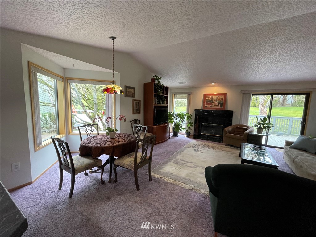 3300 Northeast 164th Street, Unit H2 Ridgefield, WA 98642 - Photo 2 of 24 a living room with furniture a fireplace and a flat screen tv