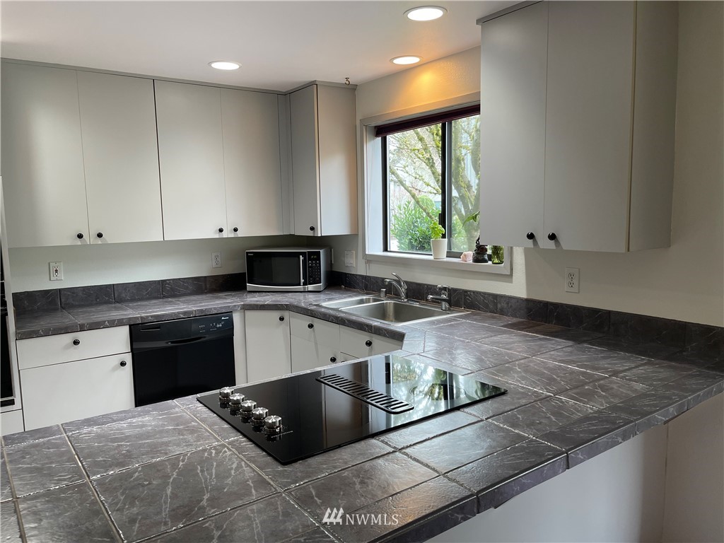 3300 Northeast 164th Street, Unit H2 Ridgefield, WA 98642 - Photo 3 of 24 a kitchen with granite countertop a stove a sink and a granite counter tops