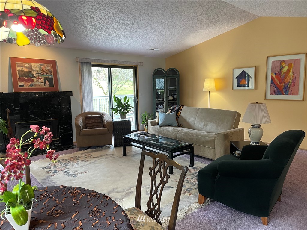 3300 Northeast 164th Street, Unit H2 Ridgefield, WA 98642 - Photo 7 of 24 a living room with furniture a flat screen tv and a fireplace