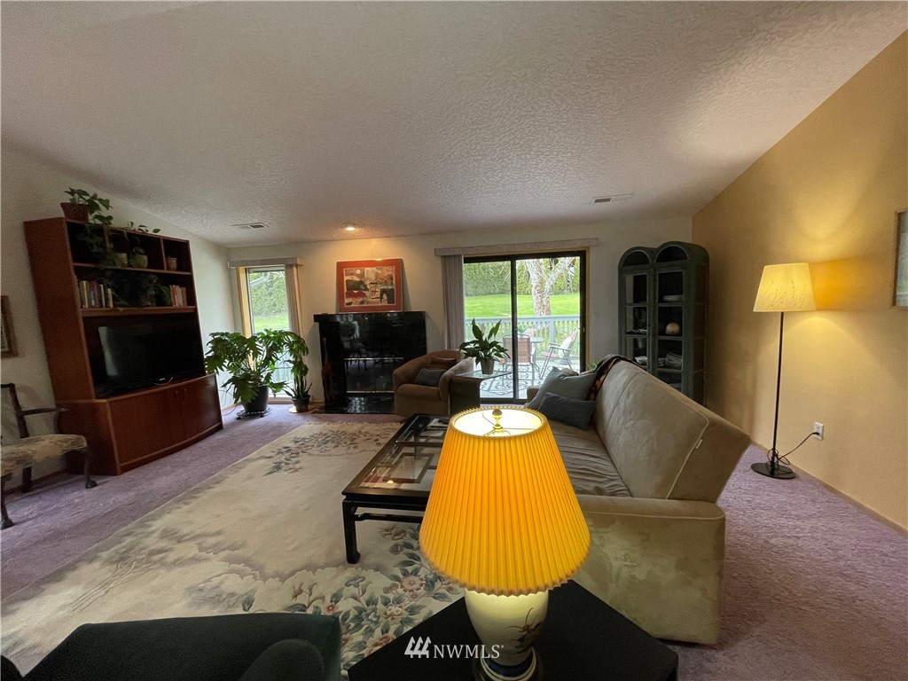 3300 Northeast 164th Street, Unit H2 Ridgefield, WA 98642 - Photo 8 of 24 a living room with furniture a flat screen tv and a large window