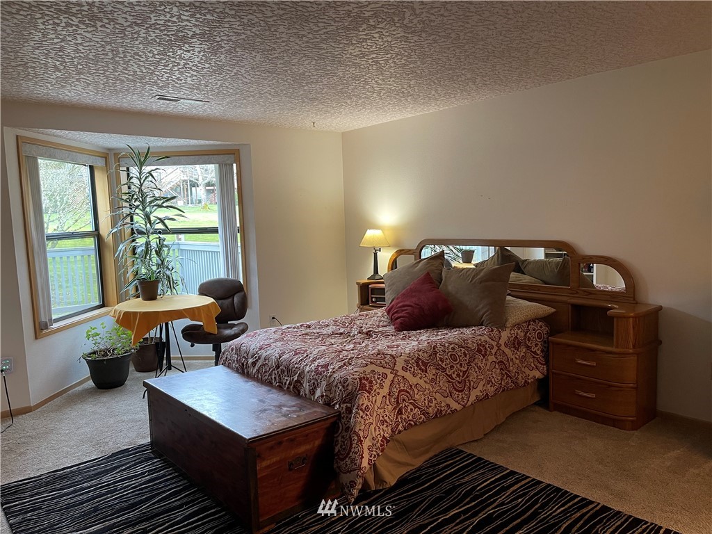 3300 Northeast 164th Street, Unit H2 Ridgefield, WA 98642 - Photo 9 of 24 a bedroom with a bed and window