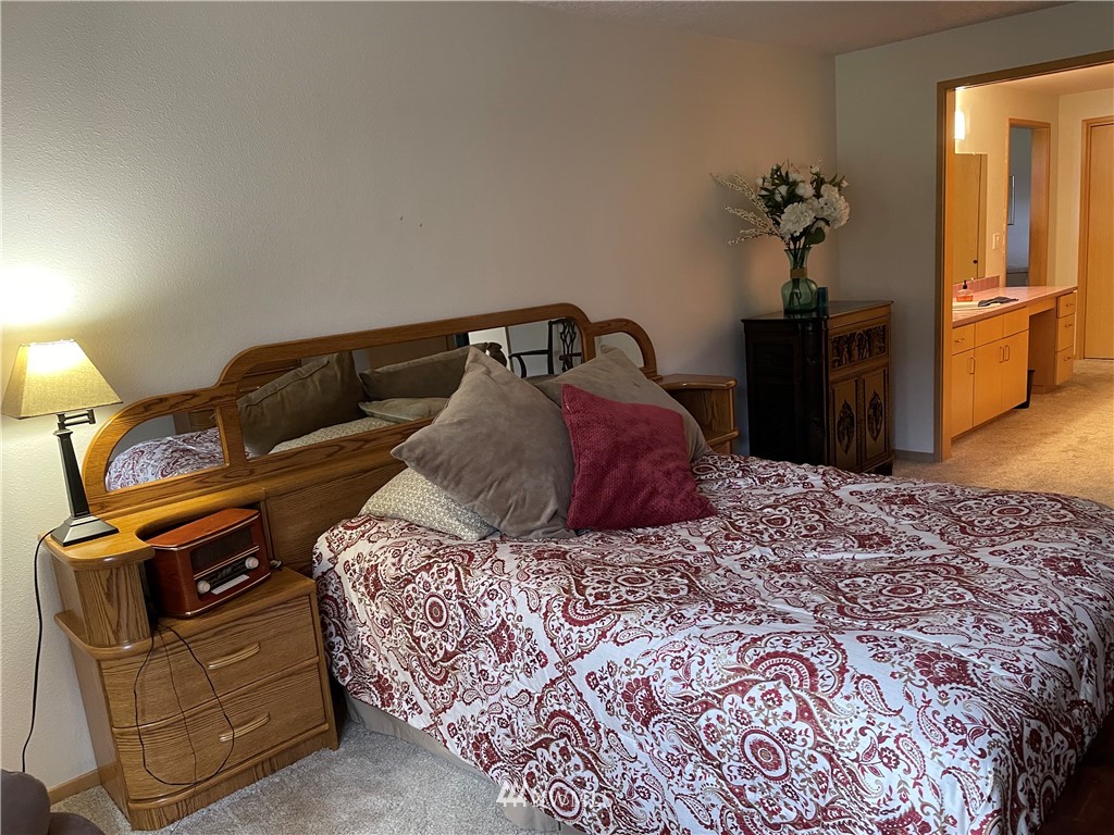 3300 Northeast 164th Street, Unit H2 Ridgefield, WA 98642 - Photo 10 of 24 a bedroom with a bed and a dresser