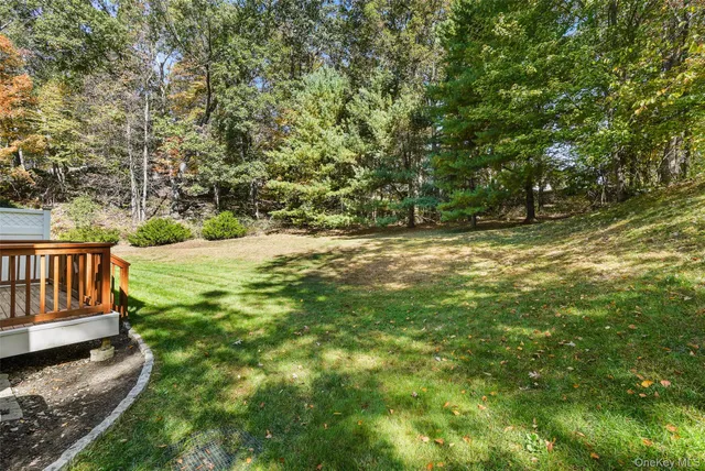 a view of a yard with wooden fence