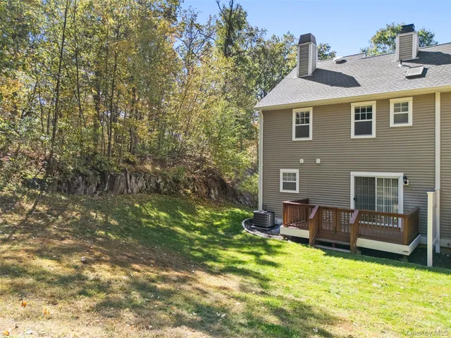 a backyard of a house with yard table and chairs