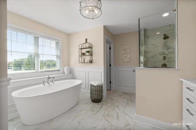 a bedroom with a large bed potted plant and a window