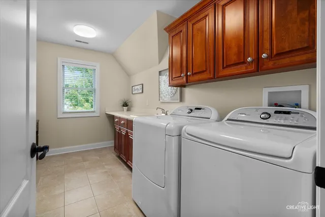 a bedroom with a bed a chair and a large window