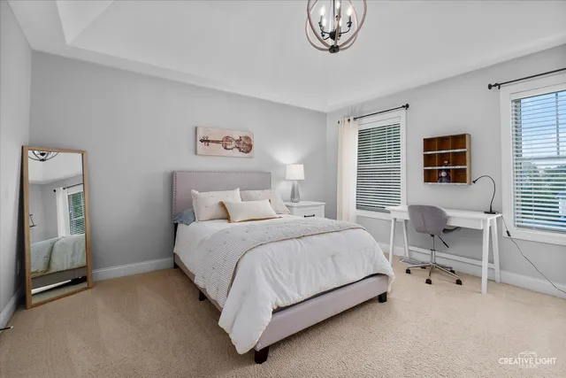 a view of a hallway with bedroom and wooden floor