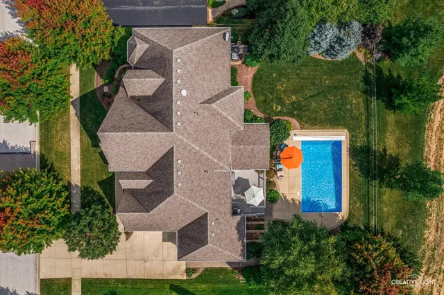 an aerial view of a house with a yard