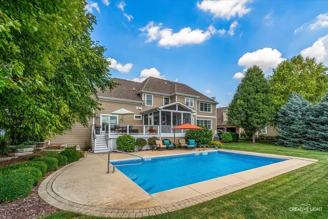 an aerial view of a house with a garden and lake view