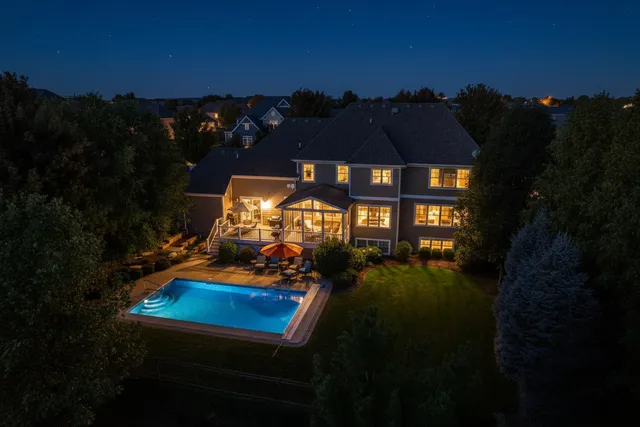 a view of a chairs and table in backyard