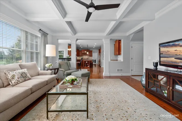 a living room with furniture a flat screen tv and a rug