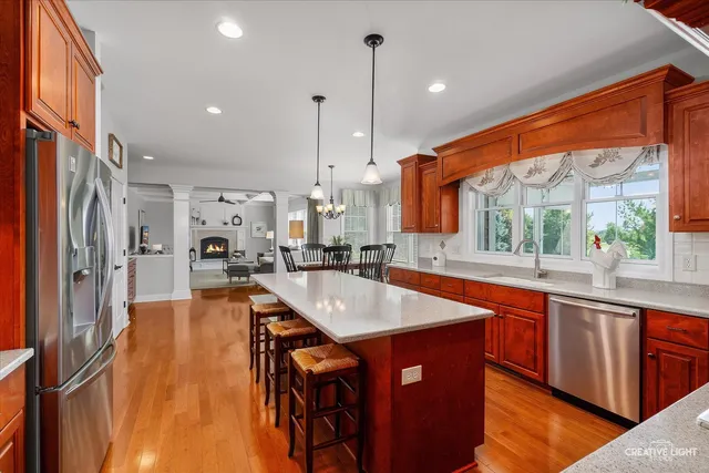 a kitchen with stainless steel appliances granite countertop sink stove and refrigerator