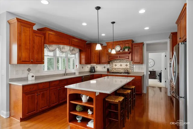 a large kitchen with a table and chairs in it