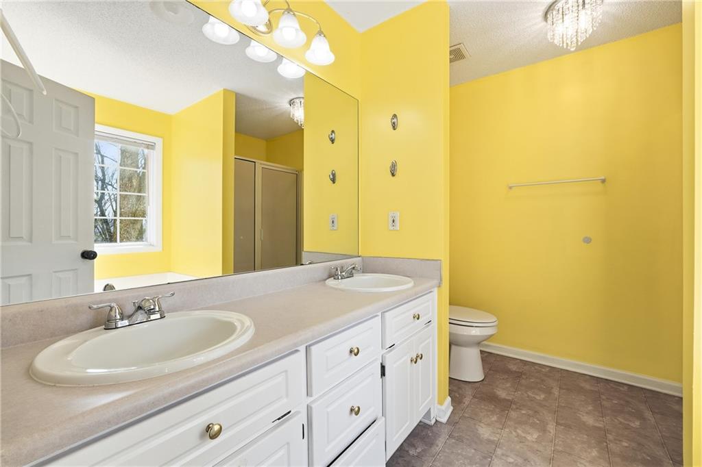 186 Franklin Court Jasper, GA 30143 - Photo 12 of 30 a bathroom with a granite countertop sink and a mirror
