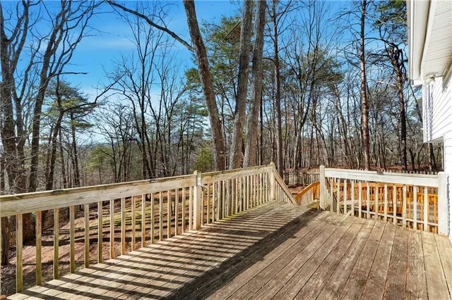 a view of a wooden deck with trees