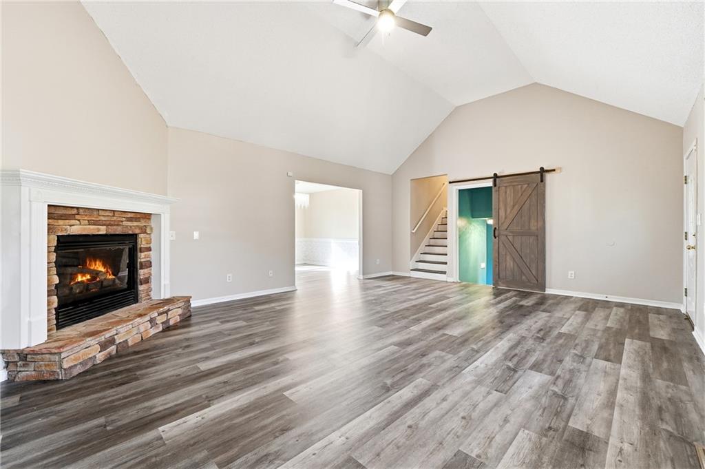 186 Franklin Court Jasper, GA 30143 - Photo 4 of 30 a view of an empty room with wooden floor fireplace and a window