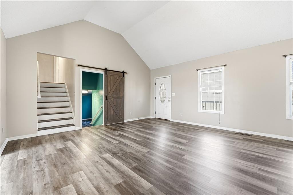 186 Franklin Court Jasper, GA 30143 - Photo 5 of 30 a view of an empty room with wooden floor and a window