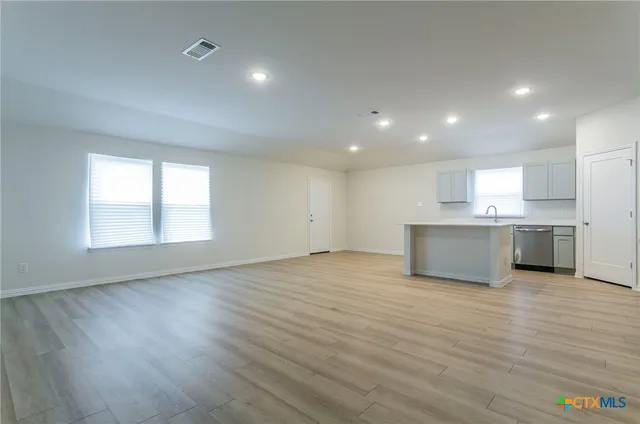 a view of kitchen with wooden floor and windows
