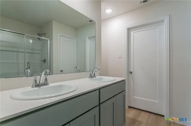 a bathroom with a sink and a mirror