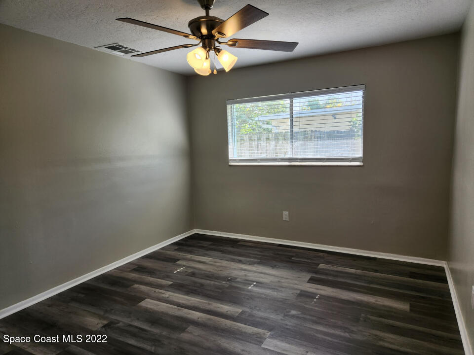 1267 Cotton Road Northeast Palm Bay, FL 32905 - Photo 16 of 30 a view of room with window and ceiling fan