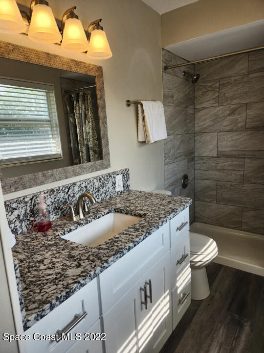 1267 Cotton Road Northeast Palm Bay, FL 32905 - Photo 24 of 30 a bathroom with a granite countertop sink and a toilet