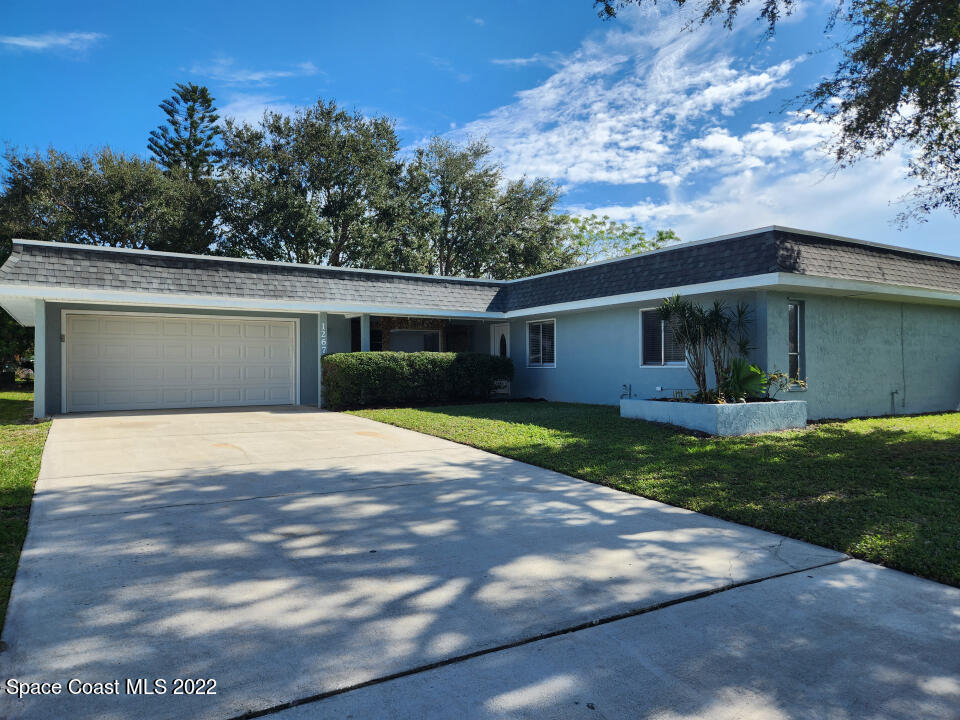 1267 Cotton Road Northeast Palm Bay, FL 32905 - Photo 26 of 30 a view of a house with backyard and garden