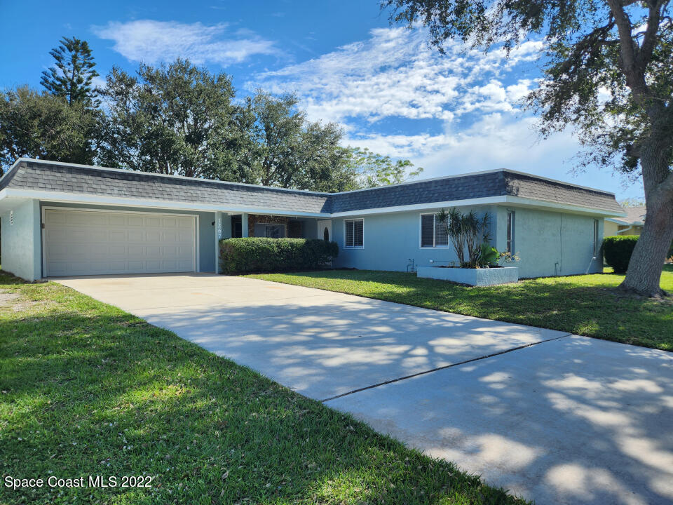 1267 Cotton Road Northeast Palm Bay, FL 32905 - Photo 27 of 30 a front view of house with yard and green space