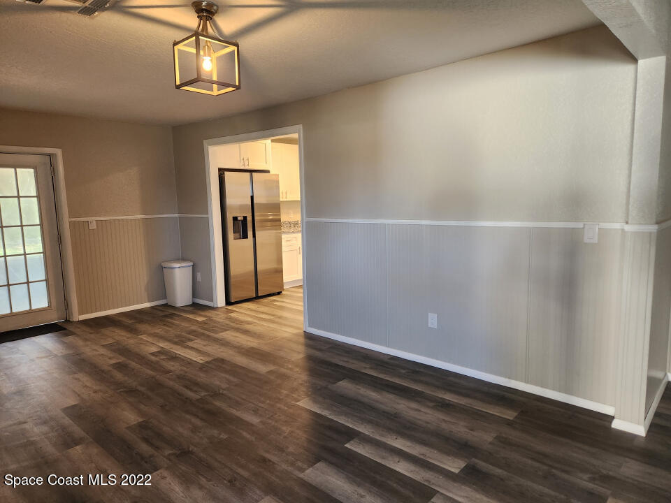 1267 Cotton Road Northeast Palm Bay, FL 32905 - Photo 5 of 30 a view of empty room with wooden floor and window