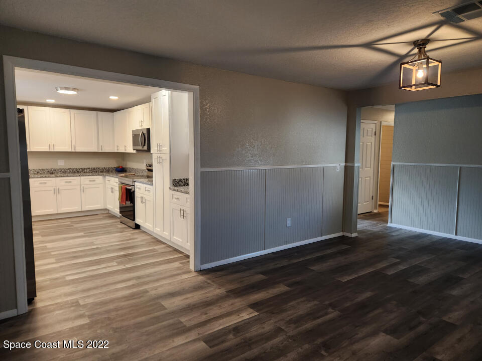 1267 Cotton Road Northeast Palm Bay, FL 32905 - Photo 8 of 30 a view of a kitchen with a sink and wooden floor