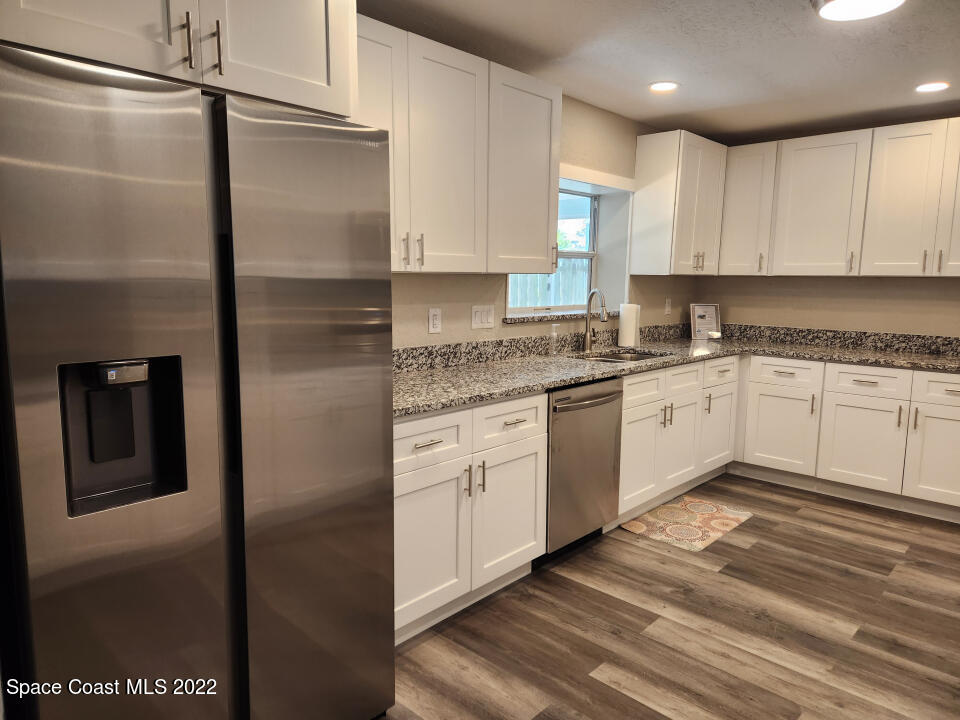 1267 Cotton Road Northeast Palm Bay, FL 32905 - Photo 9 of 30 a kitchen with a sink stainless steel appliances and cabinets