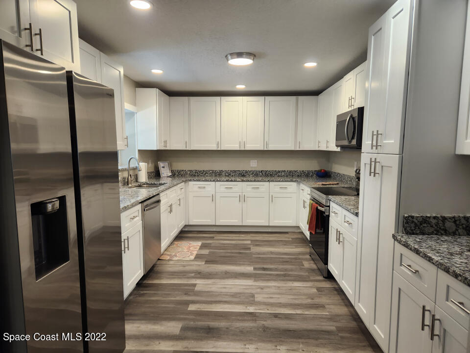 1267 Cotton Road Northeast Palm Bay, FL 32905 - Photo 10 of 30 a large kitchen with cabinets stainless steel appliances and a counter top space