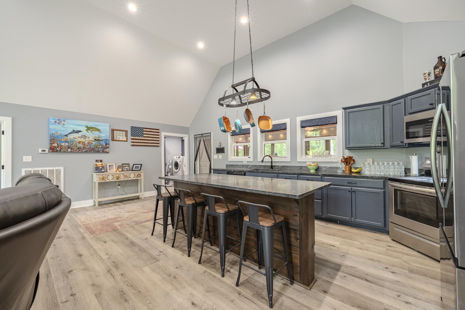 315 Timber Ridge Drive Counce, TN 38326 - Photo 10 of 40 a kitchen with stainless steel appliances granite countertop a stove top oven a sink a dining table and chairs with wooden floor