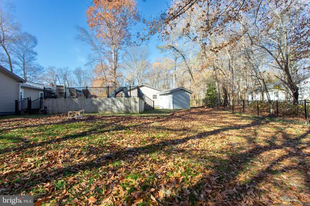 a kitchen with stainless steel appliances granite countertop a refrigerator a stove a sink dishwasher a microwave oven with cabinets and wooden floor