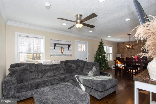 a view of a dining room with furniture and chandelier
