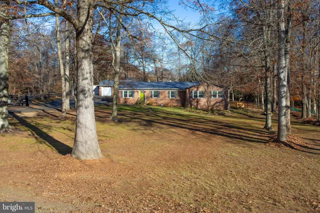 a view of a yard with wooden fence