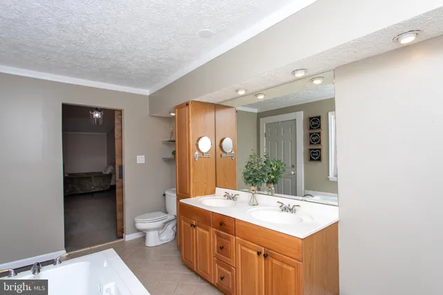 a bedroom with a bed and painting on the wall