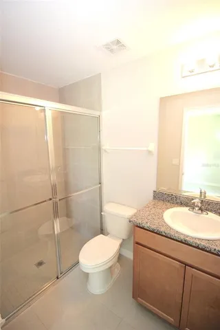 an empty room with a bench and a sink