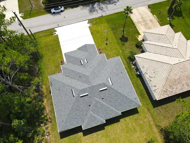 an aerial view of a house with a swimming pool