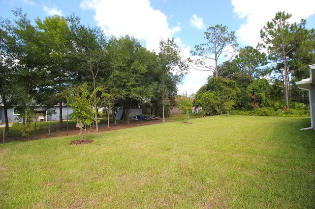 a swimming pool with outdoor seating and yard
